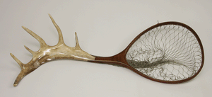Walnut frame with caribou landing net handle.