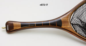 Close up of landing net handle of segmented black palm and zebra wood.