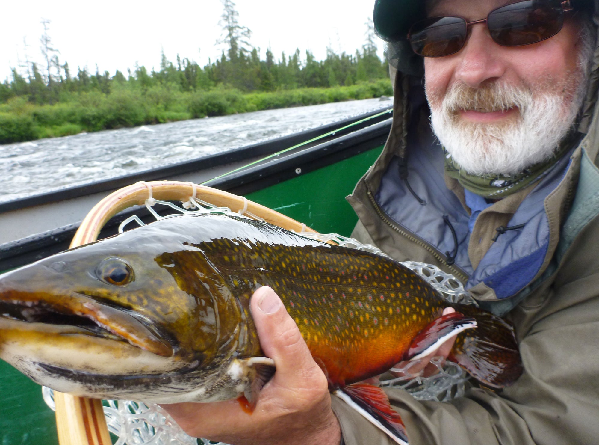 Man holding a large brook trout.
