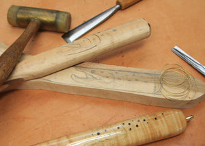 Collection of tools and material for brass inlay, with example of process.