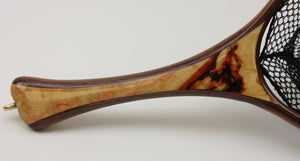 HANDLE OF A LANDING NET WITH ANGLED TIP AND CREAM COLORED WOOD AND DARK RED MARKINGS