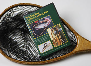 Displays the cover of a DVD laying on a landing net.