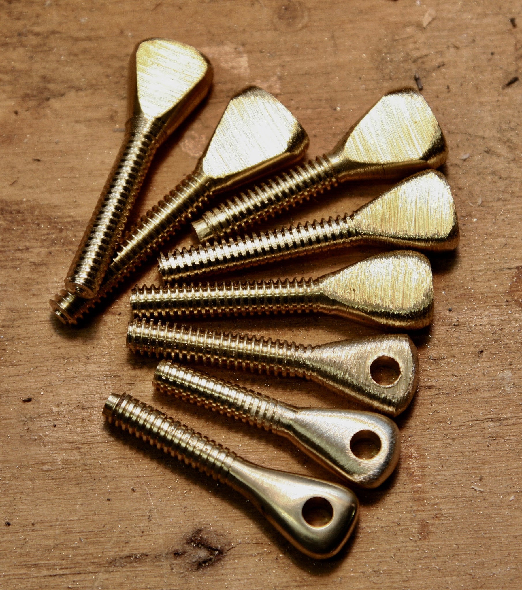 Brass eyes cut from brass rod, shown in the steps of manifactoring.