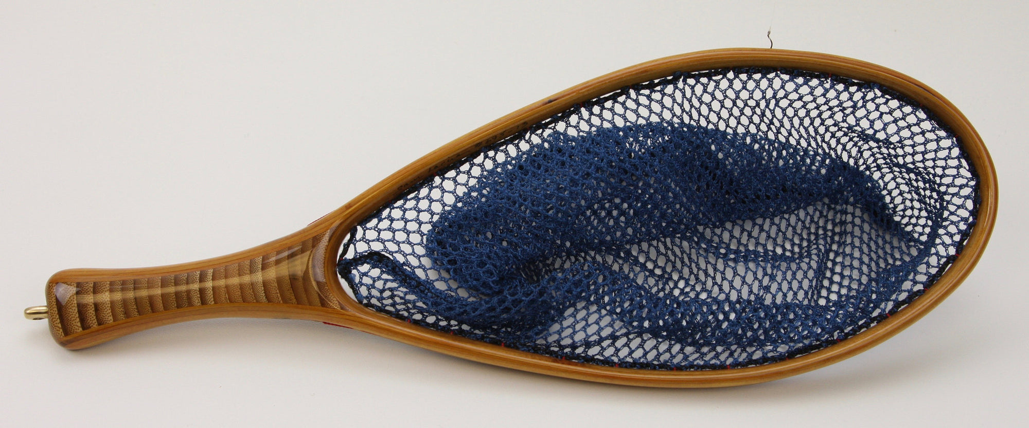 Small trout net with bamboo handle and blue net bag.