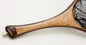 Close up of landing net handle with birds eye maple and dark wood end cap.