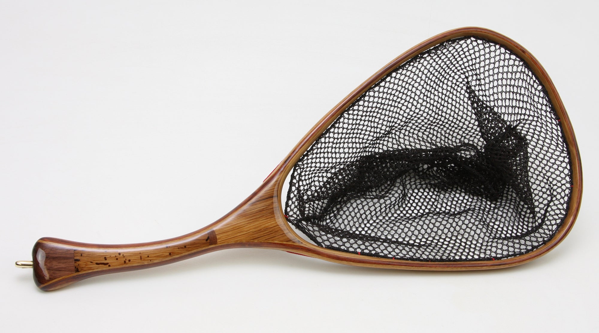 Small trout net with curved handle, brown in color.