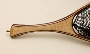 Close up of a fly fishing net with curly maple handle.