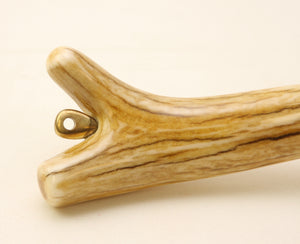 Close up of elk antler landing net handle and brass eye.