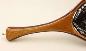 Close up of landing net handle with light colored wood.