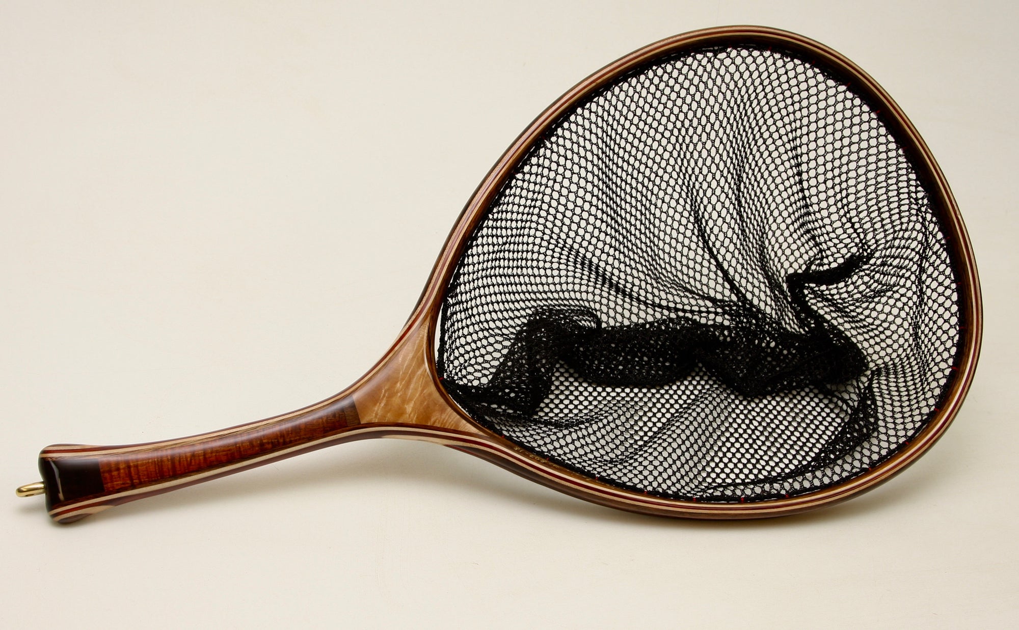 Landing net of maple and koa with a gently curved hand.
