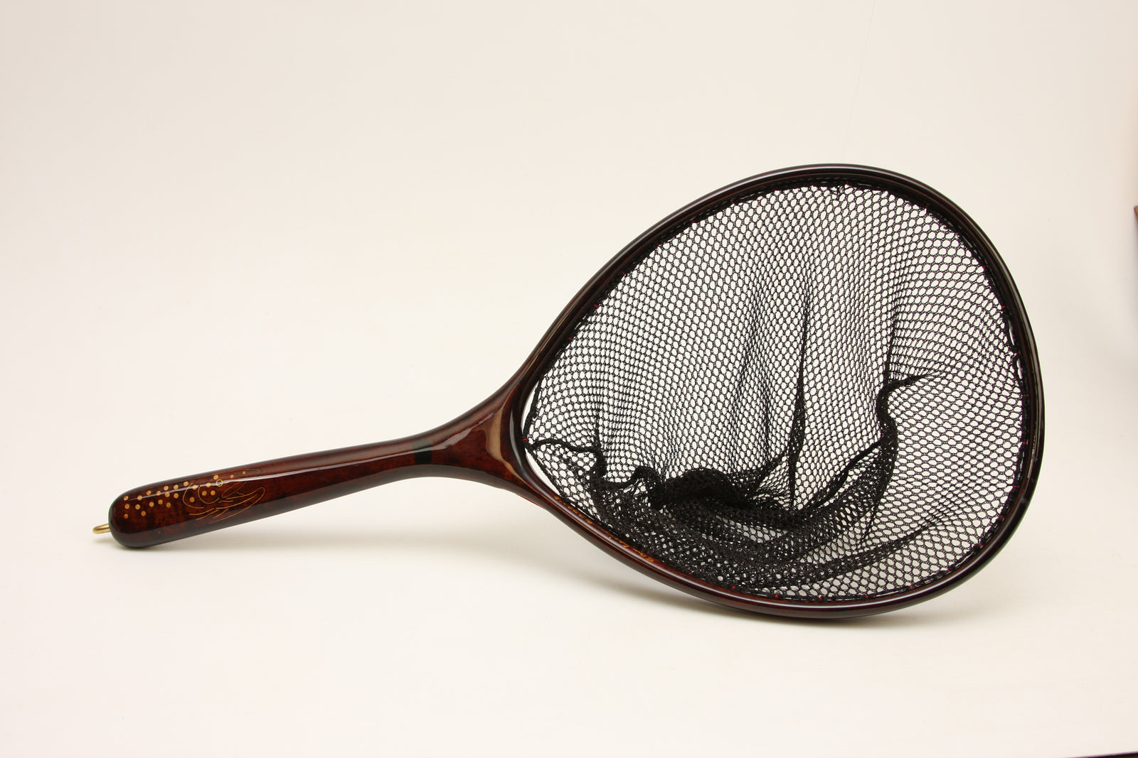 Dark colored landing net with brass inlay.