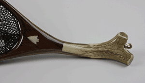 Close-up of elk antler landing net handle handle and arrowhead inset.  