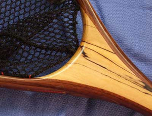 Close up of landing net handle with spalted maple.
